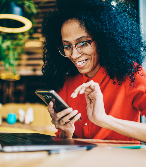 woman using phone and laptop to access InterFAX+AI document management