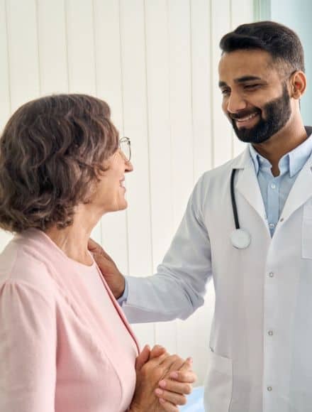 A compassionate healthcare professional discussing patient care, illustrating the personal touch in cloud fax HLTH enhanced healthcare workflows.