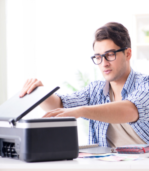 employee frustrated with using a traditional fax machine he prefers InterFAX Cloud Fax