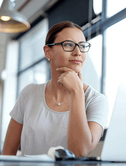 Woman in data-driven era looks out window at work