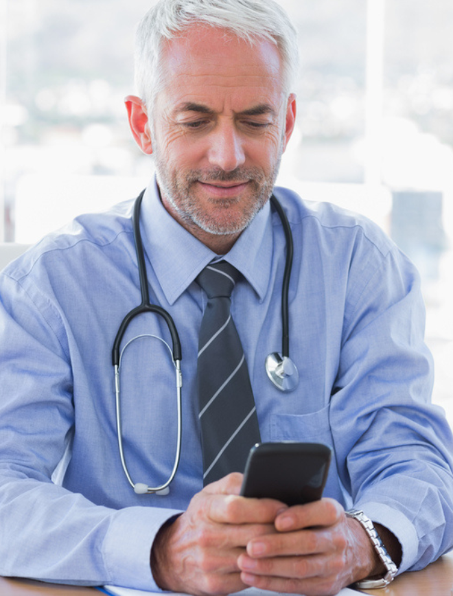 doctor looks at labs on phone