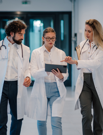 3 doctors look over results on tablet