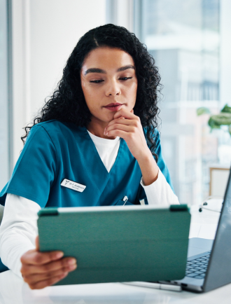 Medical professional looks at tablet