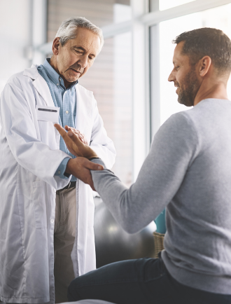 doctor examines man's hand