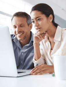 Two professionals collaborating over a laptop, likely discussing the security features of online faxing services.