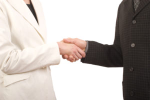 white man and woman - business handshake
