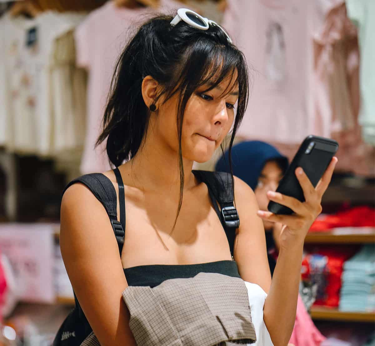 Woman receiving information sent from text messaging software for retail stores