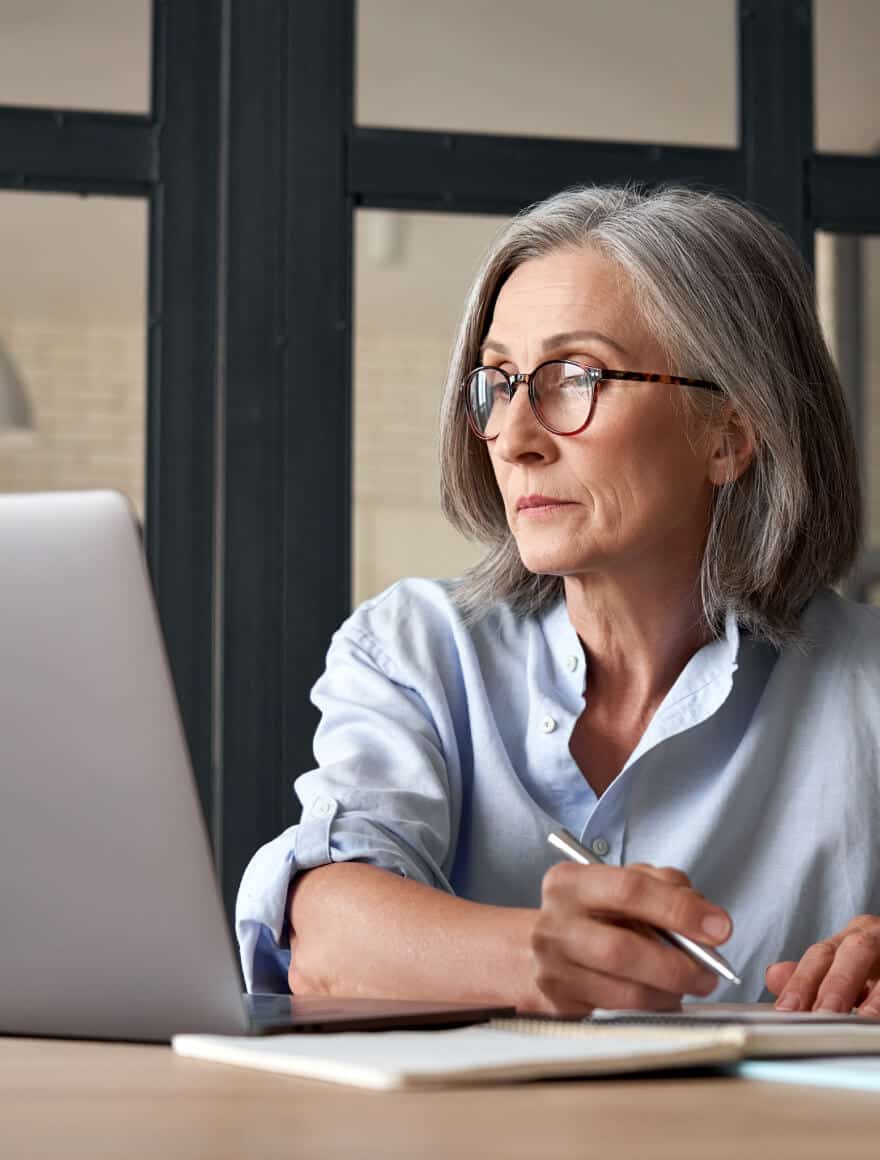Woman looks at RFP response rate on laptop